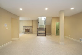 Basement with stone fireplace Basement Conversion